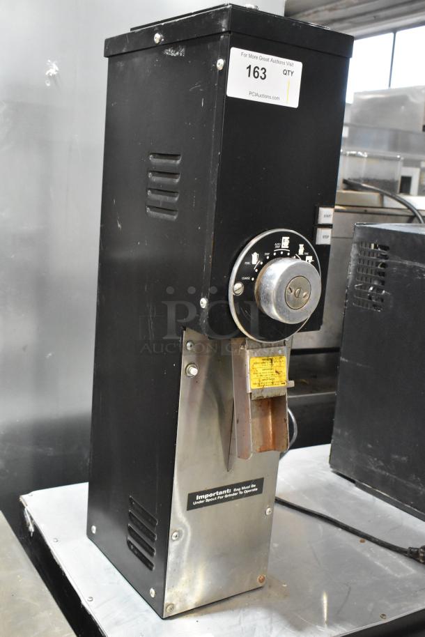 Grindmaster 890-B-T commercial coffee grinder, metal body, 115 volts, used condition, visible wear, operation label included.