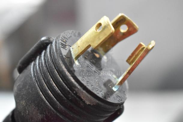 Close-up of a three-prong power plug for a Schaerer Barista commercial espresso machine.