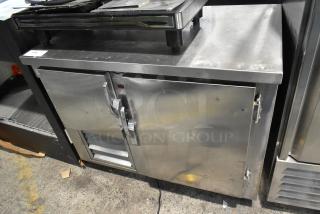 Universal Coolers stainless steel 2-door undercounter cooler. Used condition. 115 volts, 1 phase. Handles and vents visible.