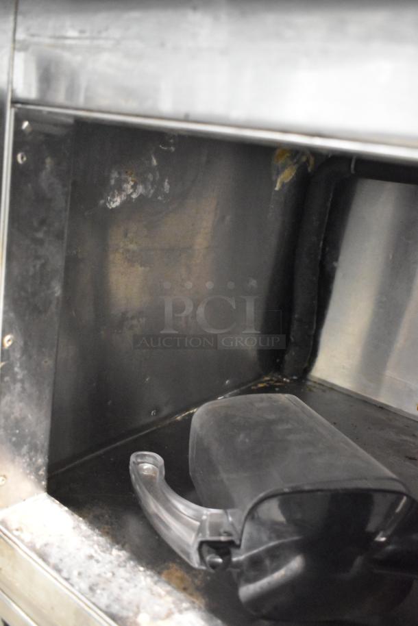 Universal Coolers stainless steel 2-door undercounter cooler interior, showing wear. 115 volts, suitable for commercial use.