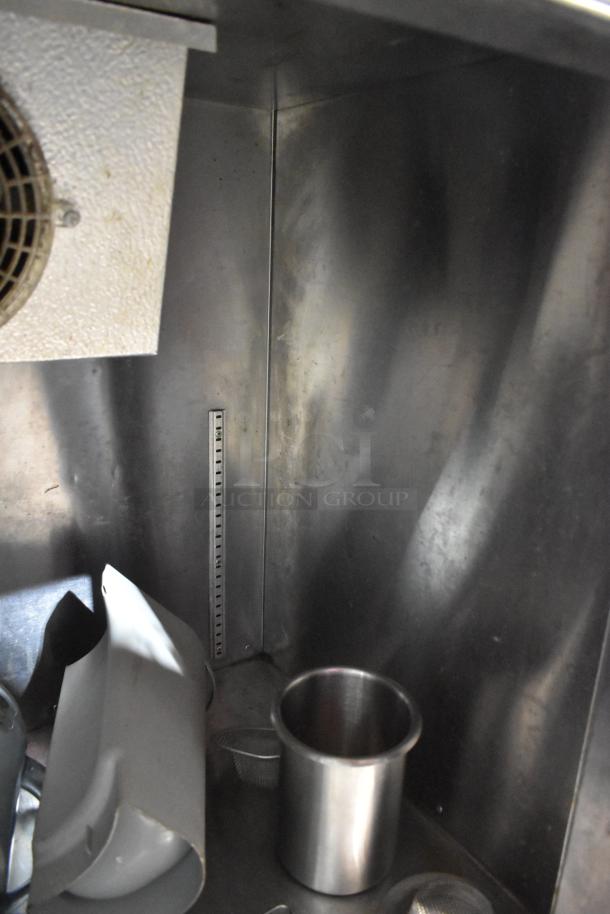 Universal Coolers stainless steel 2-door undercounter cooler interior with fan and stainless compartments visible.