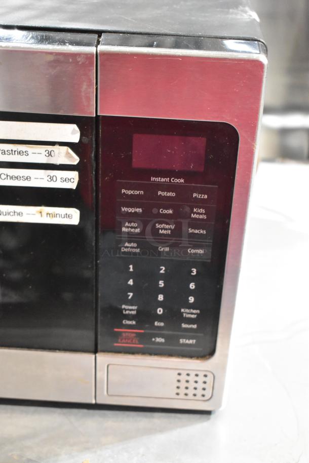 Samsung MG11H2020CT countertop microwave oven, showing control panel with instant cook options; used condition.