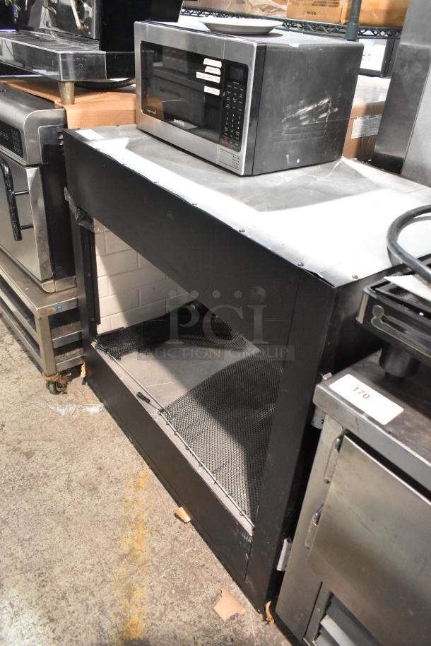 Metal table with undershelf, sturdy condition, visible wear. Ideal for kitchen or utility use. No tags or labels seen.