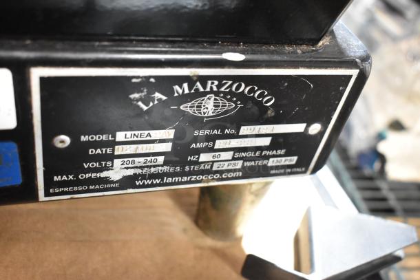 La Marzocco Linea espresso machine label showing model Linea 2AV, serial number, voltage, and pressure specifications.
