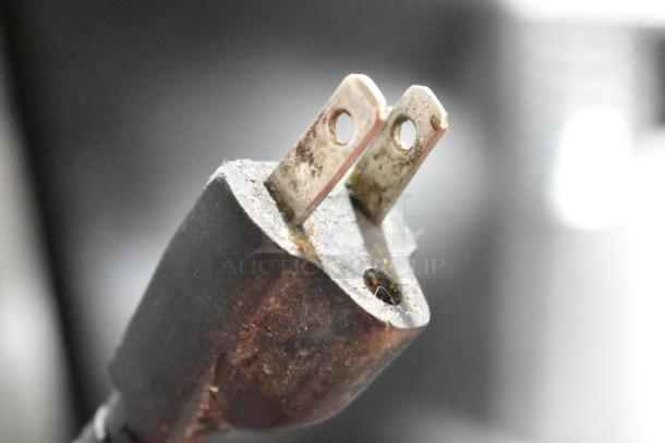 Plug of a 2019 30L Planetary Dough Mixer, 110V, close-up showing wear, suitable for commercial countertop use.