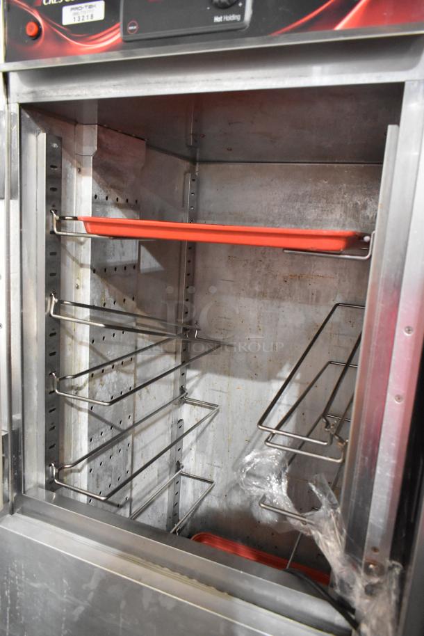 CresCor H137UA12D heated holding cabinet, metal, with commercial casters, 115V, 1 phase, interior shelves visible.