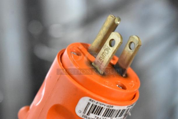 Close-up of orange Leviton electrical plug with visible barcode label on a CresCor H137UA12D heated holding cabinet.