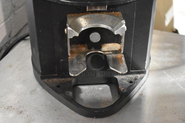 Mahlkonig Peak metal commercial espresso bean grinder base, no hopper, used condition, 120 volts, 1 phase, visible coffee residue.