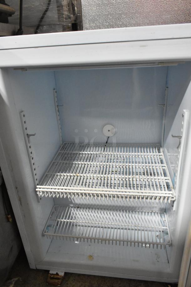 Avantco 360CFM3 Metal Mini Cooler Merchandiser, 115 volts, 1 phase, white interior with adjustable shelves, signs of use.