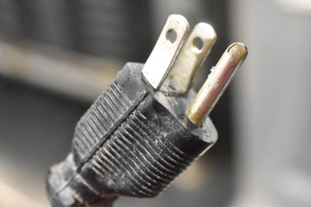 Carter Hoffmann MC2W2S heated merchandiser power plug, 120 volts, showing prongs and black ribbed casing.