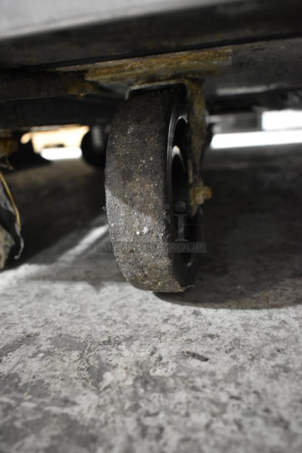 True TUC-48F commercial freezer caster. Stainless steel construction, visible wear on wheel, ideal for undercounter use.