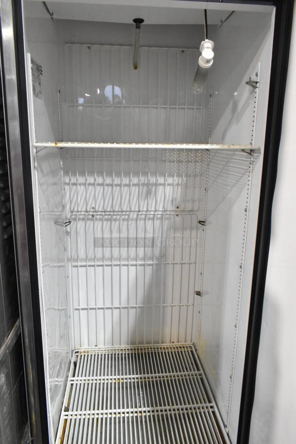 True T-23F stainless steel commercial freezer with single door, interior shelving, and visible wear. 115V, 1 phase.