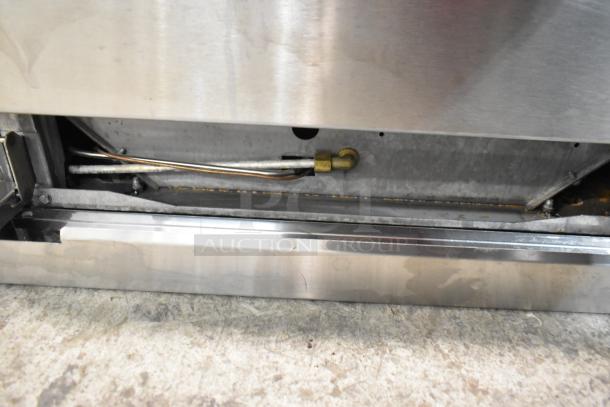 Stainless steel commercial range base showing internal gas piping, part of Cooking Performance Group CPG 351S24N.