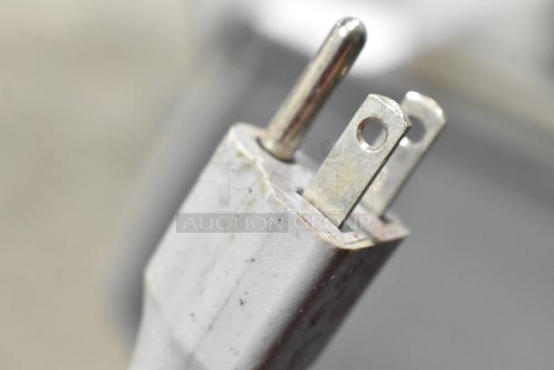 A close-up of the power plug for a Mazzer Luigi Major Electronic espresso grinder, showing signs of light wear.