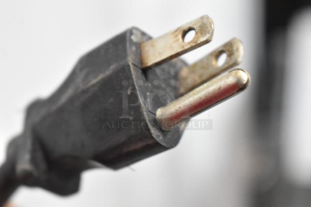 Close-up of the power plug for a Bunn G9T HD coffee bean grinder, showing three-prong configuration.