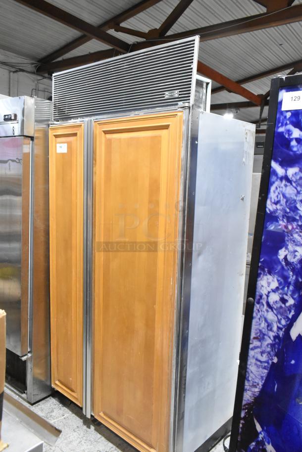 Sub-Zero wood panel 2-door reach-in cooler with freezer, stainless trim, 115 volts, 1 phase, visible model label.