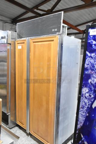 Sub-Zero wood panel 2-door reach-in cooler with freezer, stainless trim, 115 volts, 1 phase, visible model label.