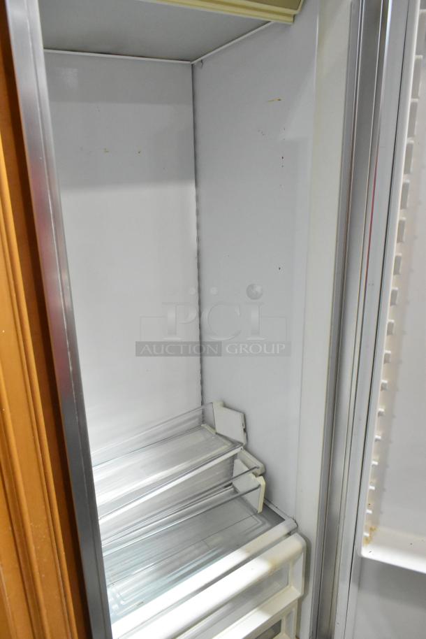 Sub-Zero Wood Panel 2 Door Reach-In Cooler with Freezer, 115V, 1 Phase. Interior shelves visible, showing clean condition.