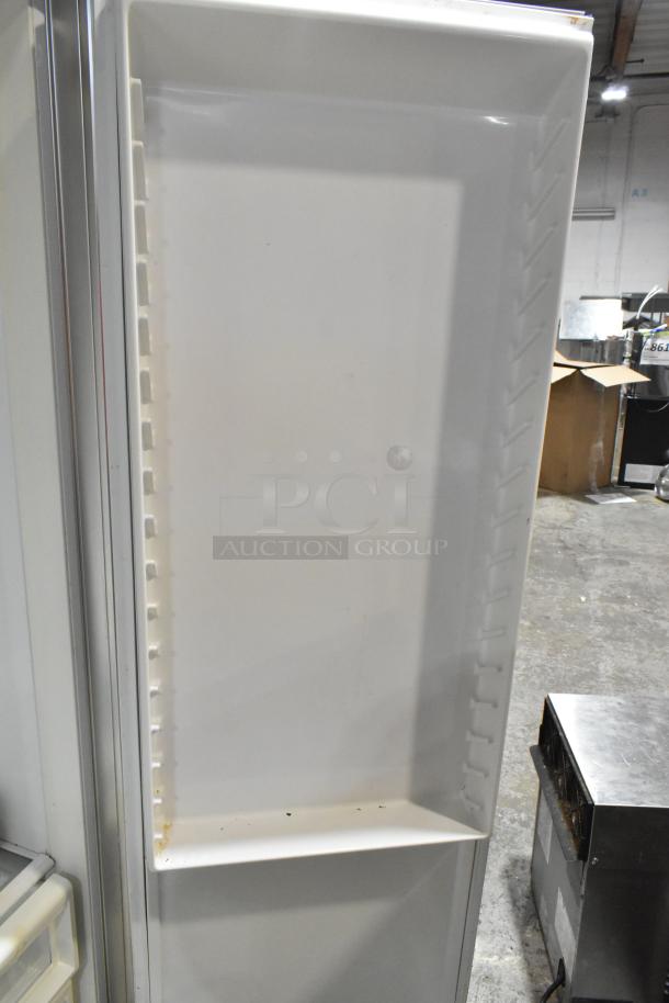 Sub-Zero wood panel 2 door reach-in cooler with freezer, 115 volts, 1 phase, showing interior shelving and condition.