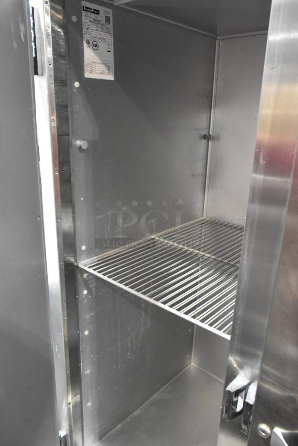2018 Traulsen G31010 stainless steel 3-door reach-in cooler with poly-coated racks, 115 volts, 1 phase; interior view.
