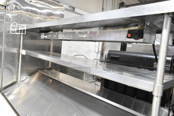 2020 Leader NLM60 stainless steel commercial prep table with 2-tier overshelf, food warming strip, on casters.