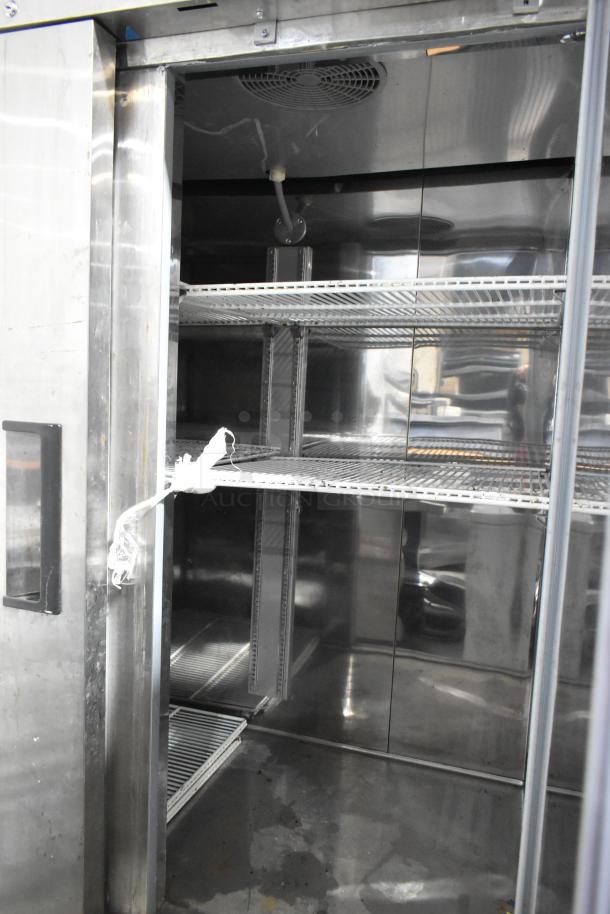 Coldline CFD-2RR-E-HC 2-door stainless steel reach-in cooler with poly coated racks, on commercial casters.