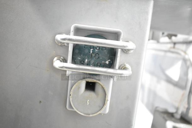 Metal commercial floor-style meat saw with visible "Push to Start" button, metal frame; used condition.