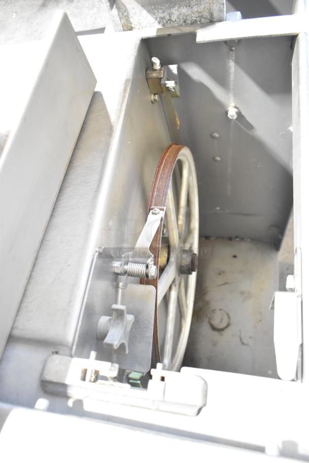 Metal commercial floor-style meat saw, featuring a robust metal frame and visible blade components, in fair condition.