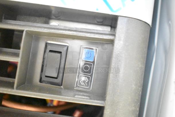 Close-up of control panel on Manitowoc UDP-0065A ice machine, showing power and operation buttons. Model 499UDP0065AA.