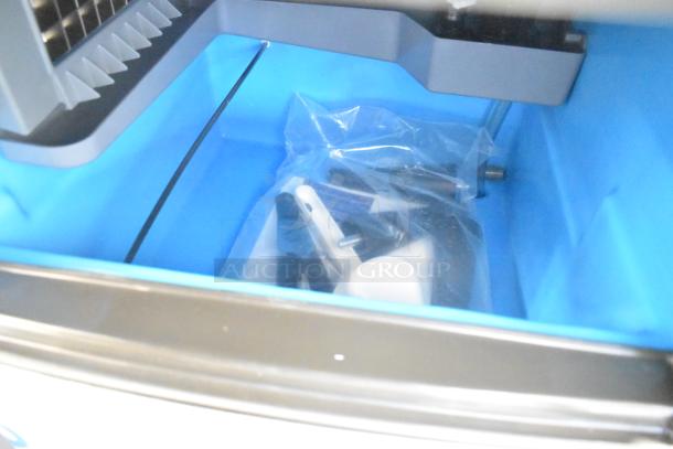 Brand new Manitowoc UDP-0065A ice machine interior with accessories. Stainless steel, 31 lb. bin, scratch and dent.