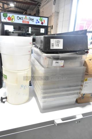 Lot of various items including poly bins and containers, featuring a black 18 in. tray with visible label, used condition.