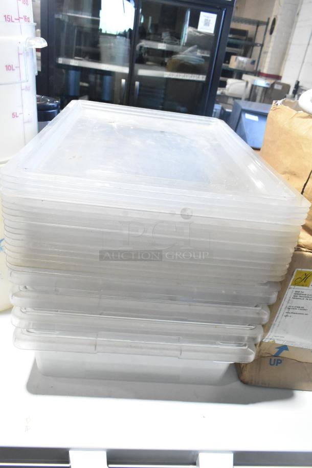 Auction lot of various items, including a stack of clear poly bins and containers. Appears in used condition.