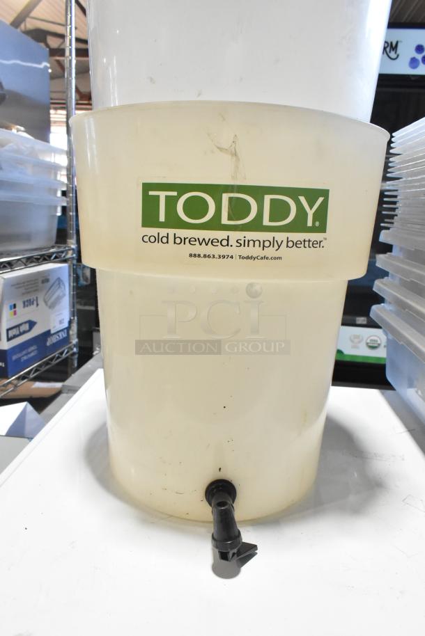 Lot of various items; features a Toddy cold brew container with spout, label visible. Used condition with scratches.