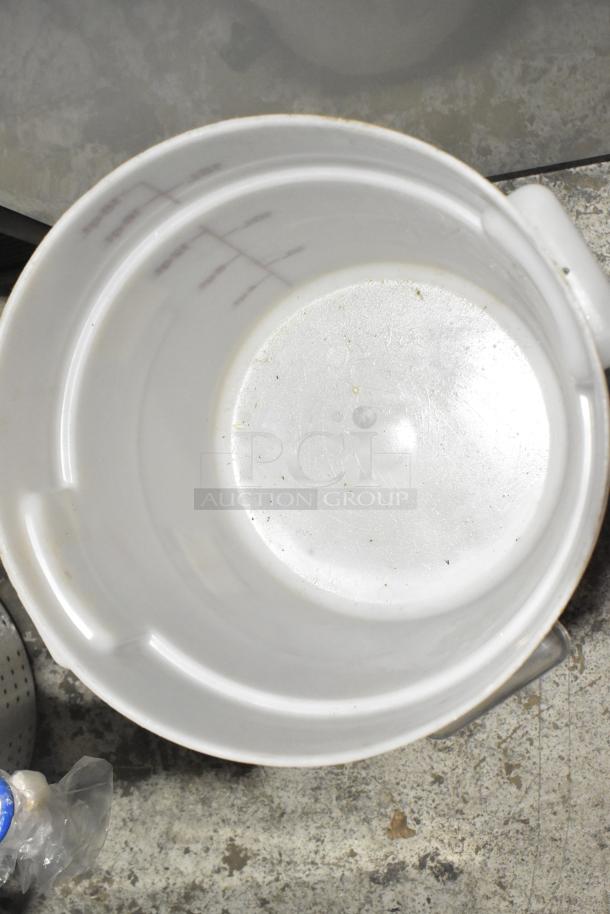 Lot of various items including white poly bin, slight scuffs visible, circular design, handles on sides.