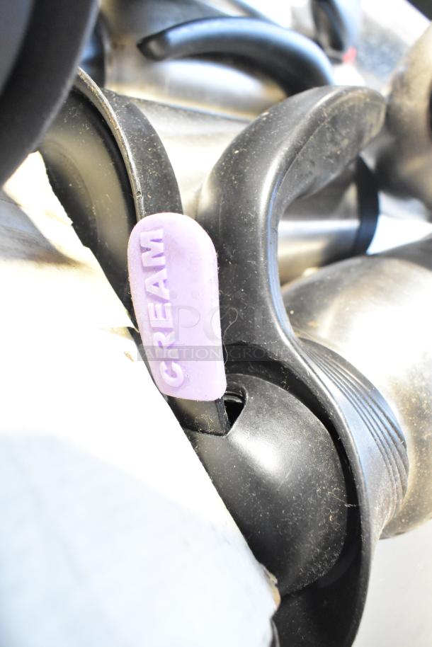 Lot of various items including dusty poly bins and containers with a "CREAM" labeled handle visible.