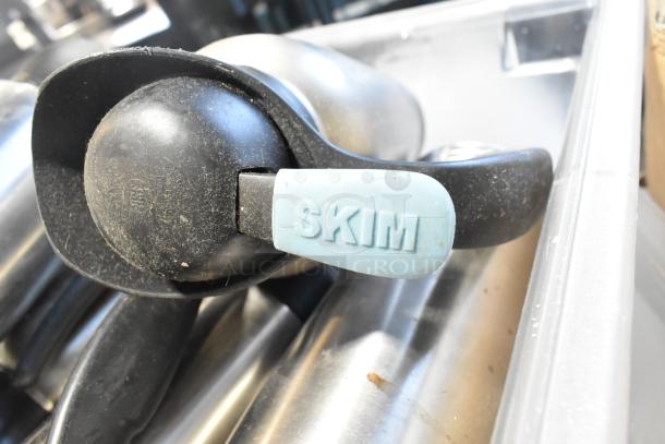 Lot of assorted items including black handle tool with "SKIM" label, stored in a clear poly bin. Signs of wear.