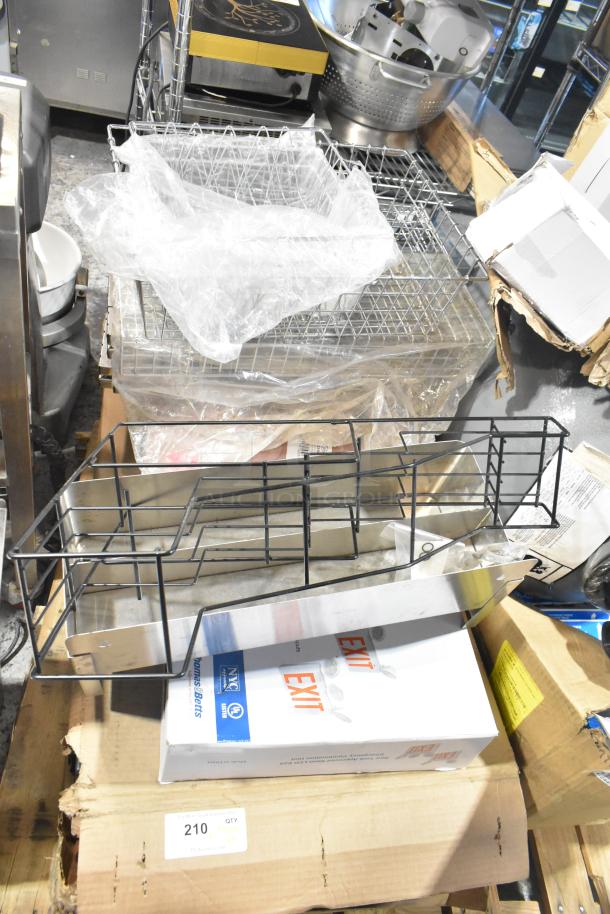 Pallet lot of items including exit signs, metal baskets, grease filters, butcher paper roll, faucet handles, and more.