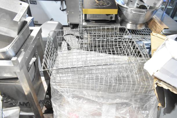 Pallet of various items including metal baskets, exit signs, and grease filters. Items appear in used condition.