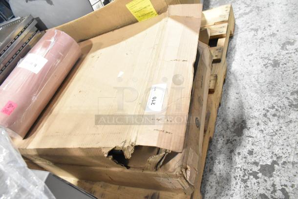 Pallet with various items including exit signs, metal baskets, grease filters, butcher paper roll, faucet handles. Some boxes are damaged.