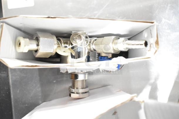 Pallet lot including metal coupler in box, suitable for plumbing or industrial use. New condition.