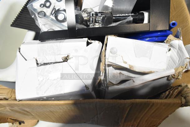 Pallet lot with exit signs, metal baskets, grease filters, peach butcher paper roll, Fisher faucet handles, and various items.