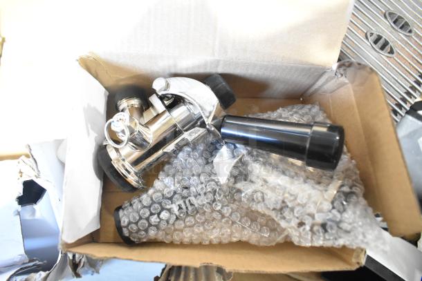 Pallet lot with various items including exit signs, metal baskets, grease filters, butcher paper, and Fisher faucet handles.