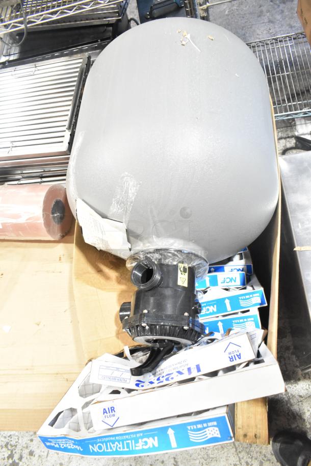 Pallet lot with exit signs, metal baskets, grease filters, Choice 43318PEA butcher paper, Fisher faucet handles, and coupler.