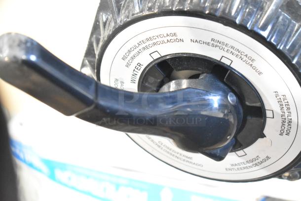 Control dial for a filter system, labeled with functions in multiple languages, including "Recirculate" and "Winter."