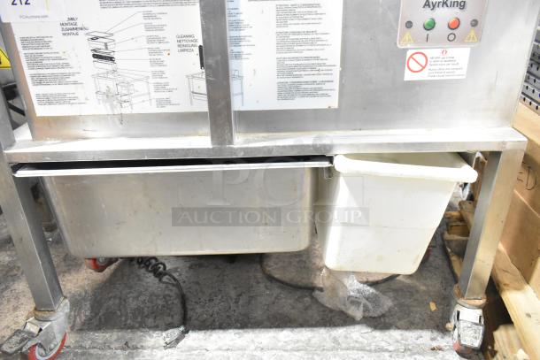 AyrKing BBS-U metal commercial breading sifting station, 115/230V, 1 Phase, with visible labels and caster wheels.
