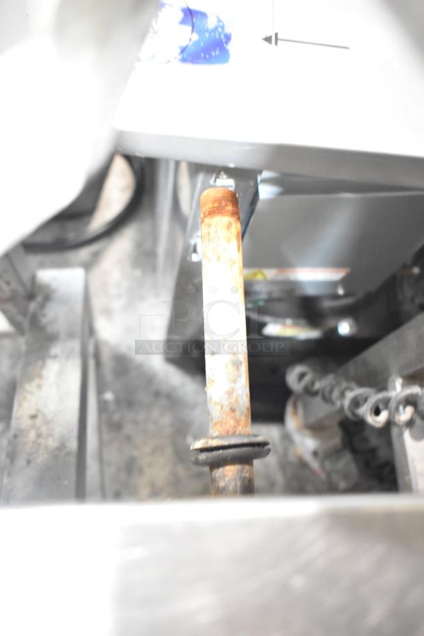 Alt Text: Stainless steel commercial braising pan in industrial condition, showing signs of rust and wear on attachments.