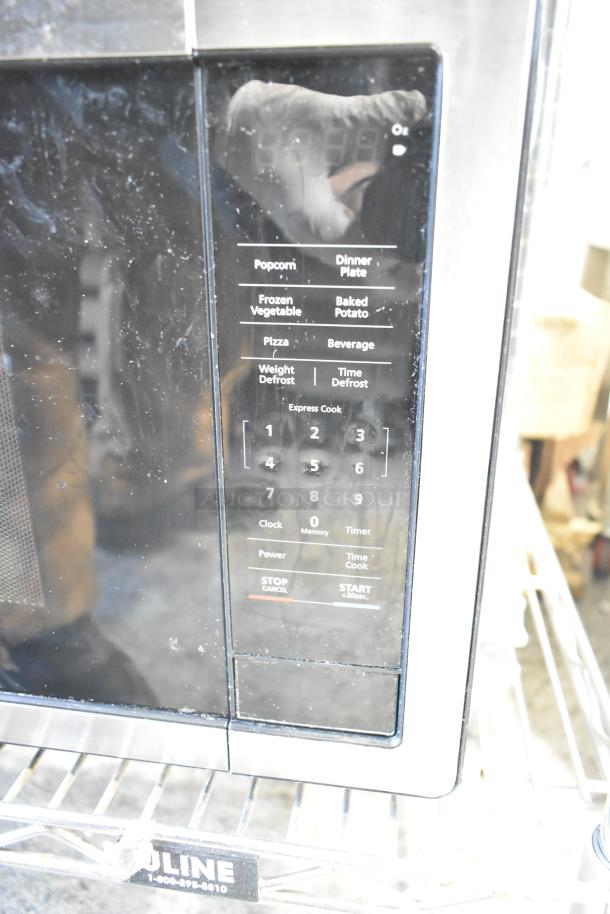 Magic Chef MC110MST metal countertop microwave oven with keypad, 120 volts, 1 phase, in used condition, includes plate.