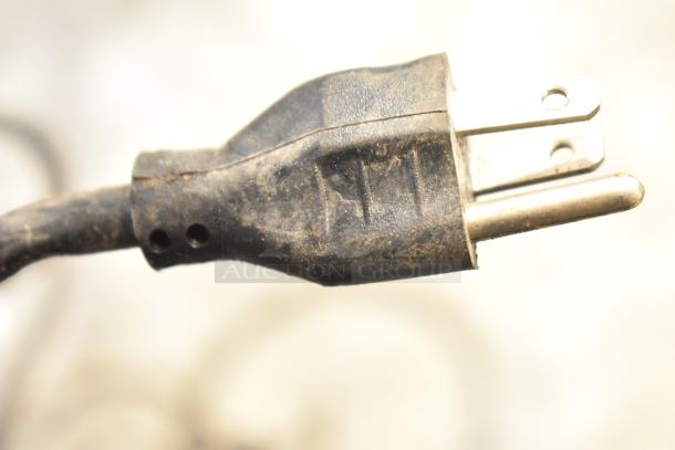 Close-up of a worn-out plug for a Lester 36 Volt Automatic SCR Battery Charger, showing signs of use.
