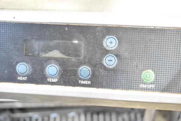 Waring WIH400 induction range control panel with buttons for heat, temp, and timer. Stainless steel, moderate wear.