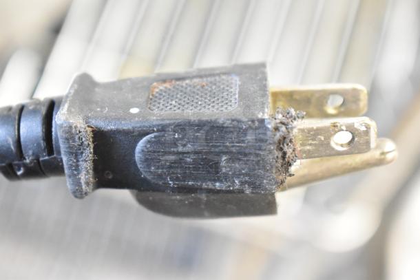 Close-up of a worn power plug, showing frayed edges and dirt buildup. For a Waring WIH400 induction range.